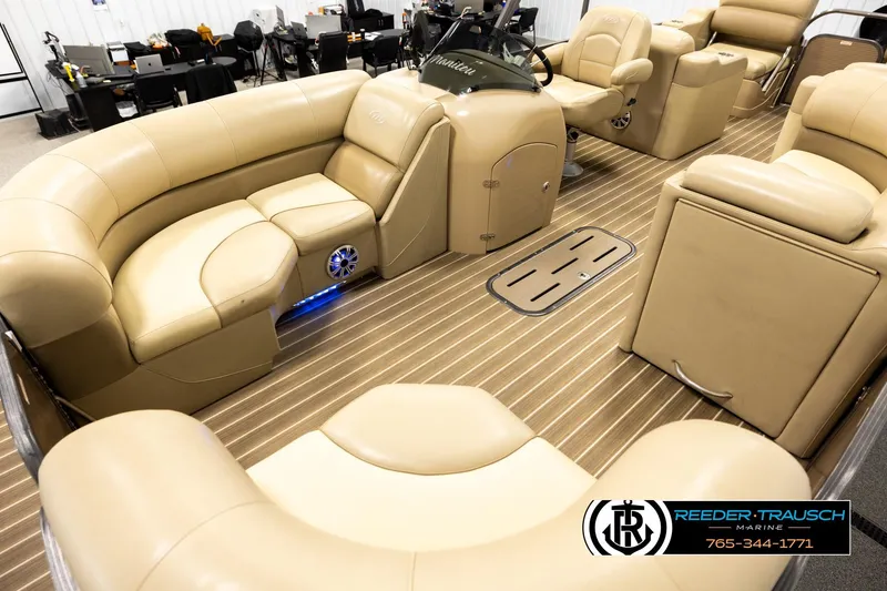 Slide: The Image of Luxurious interior of a 2017 Manitou Oasis SHP pontoon boat with beige seating. - 10