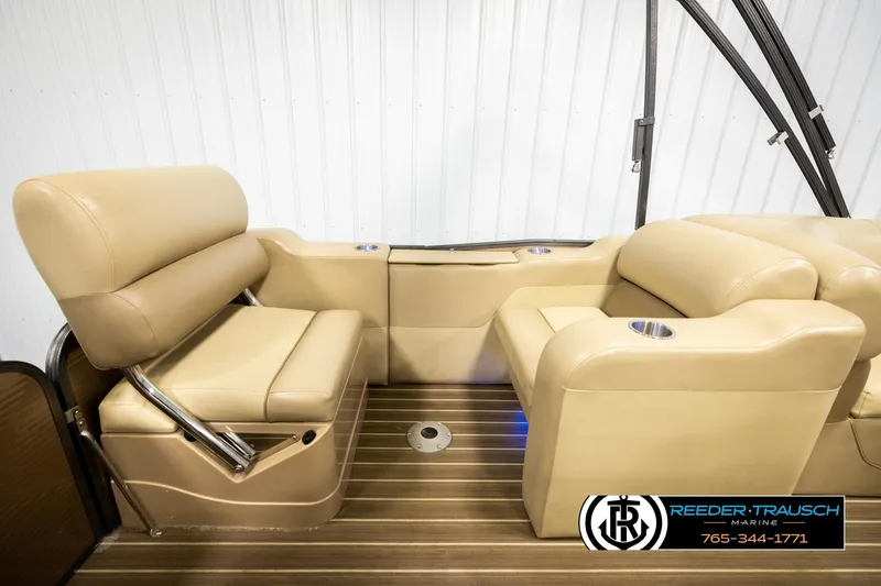 Slide: The Image of 2017 Manitou Oasis SHP boat interior with beige seating and wood flooring. - 22