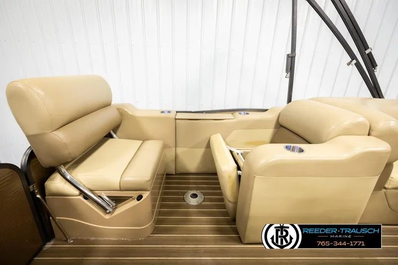 Slide: The Image of 2017 Manitou Oasis SHP boat interior with beige seating and wood flooring. - 23