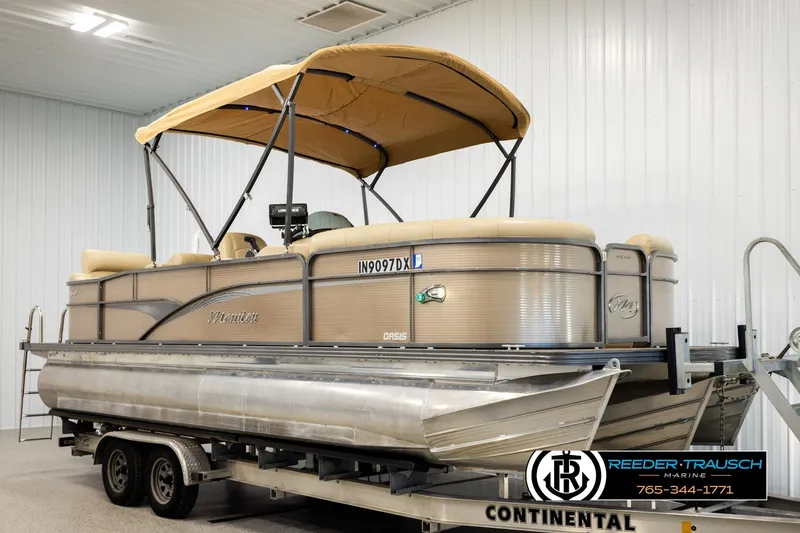 Slide: The Image of 2017 Manitou Oasis SHP pontoon boat on trailer in indoor storage facility. - 3