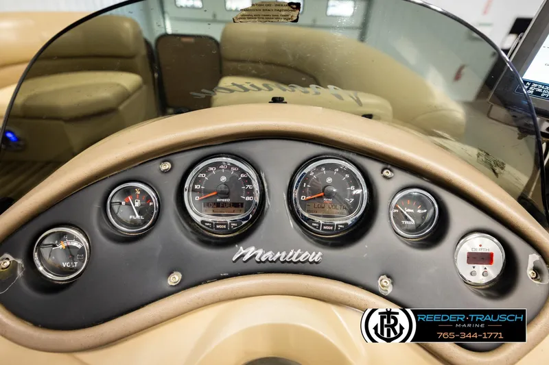 Slide: The Image of Dashboard of a 2017 Manitou Oasis SHP boat with gauges and controls. - 36