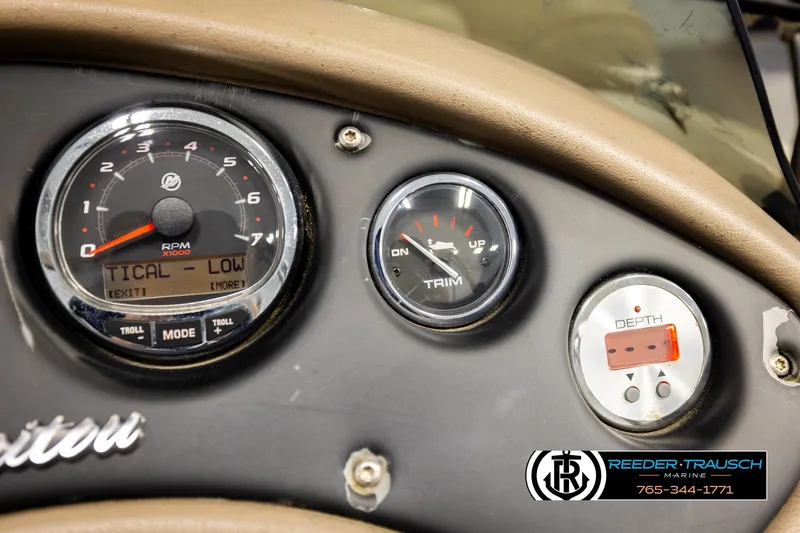 Slide: The Image of Dashboard of a 2017 Manitou Oasis SHP boat with RPM, trim, and depth gauges. - 39