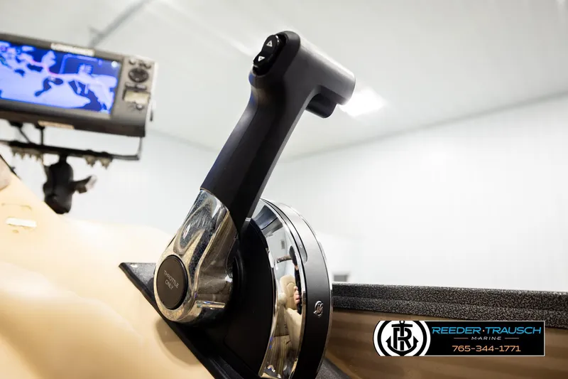 Slide: The Image of Throttle control of 2017 Manitou Oasis SHP boat with navigation screen in background. - 42