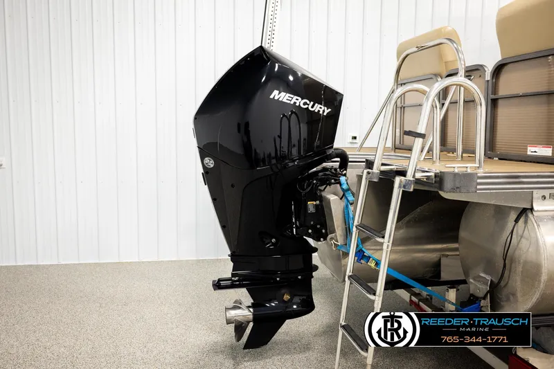Slide: The Image of 2017 Manitou Oasis SHP pontoon boat with Mercury outboard motor in showroom. - 49