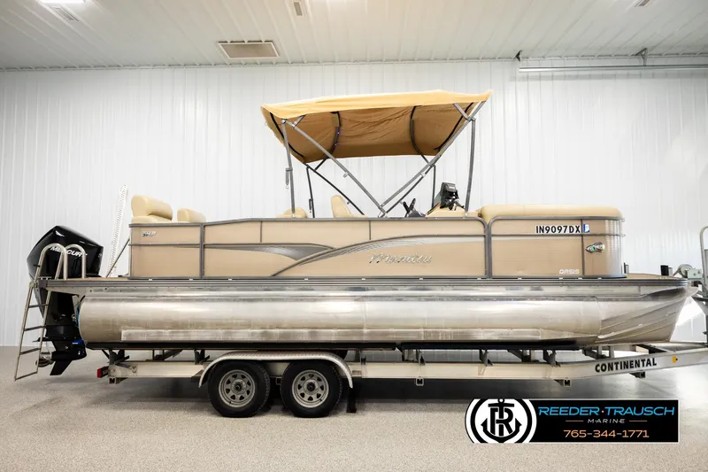 Slide: The Image of 2017 Manitou Oasis SHP pontoon boat on trailer in indoor showroom. - 5