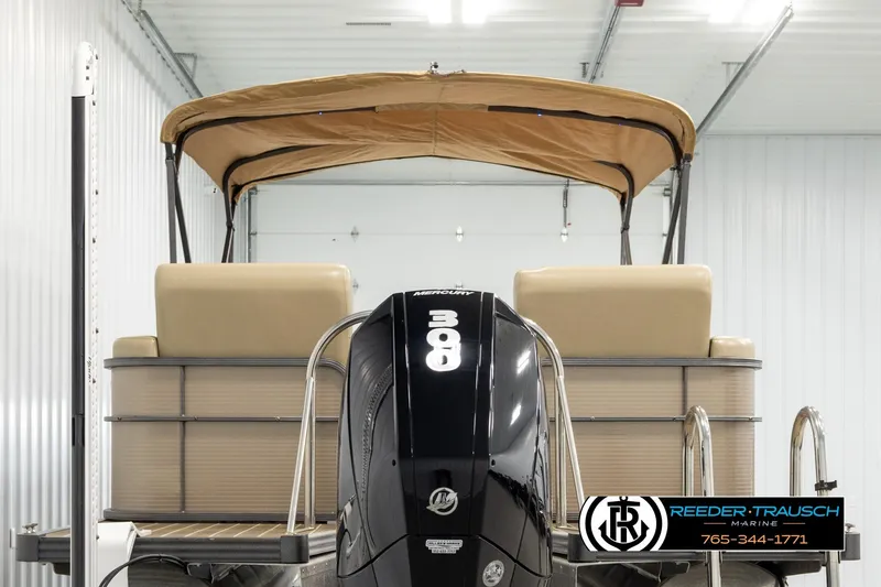 Slide: The Image of 2017 Manitou Oasis SHP pontoon boat with Mercury 300 engine in a storage facility. - 7