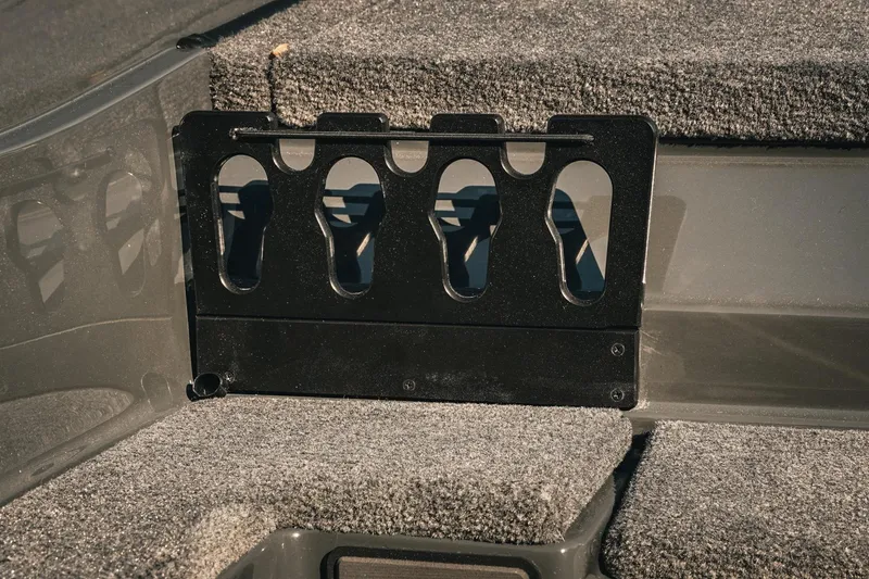 Slide: The Image of Phoenix 721 ZXL 2026 boat interior with rod holder and carpeted flooring. - 17