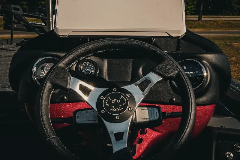 Slide: The Image of Steering wheel of 2026 Phoenix 721 ZXL boat with dashboard gauges. - 19