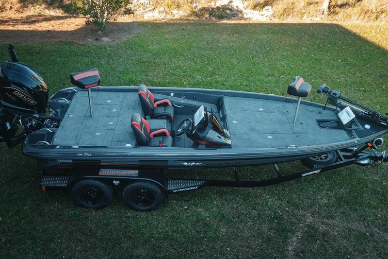Slide: The Image of 2026 Phoenix 721 ZXL bass boat on trailer, parked on grass. - 2