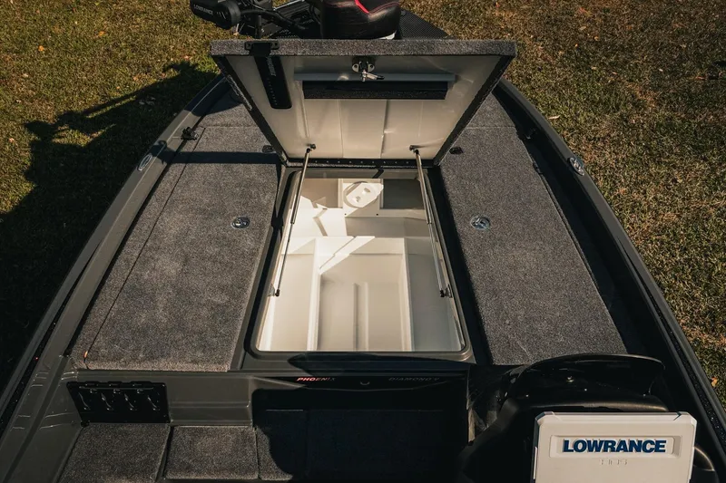 Slide: The Image of 2026 Phoenix 721 ZXL boat interior with open storage compartment and Lowrance electronics. - 21