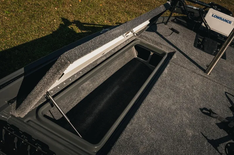 Slide: The Image of Open storage compartment on 2026 Phoenix 721 ZXL boat with Lowrance equipment. - 23