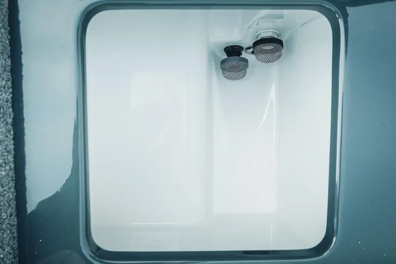 Slide: The Image of Interior view of 2026 Phoenix 721 ZXL storage compartment with dual drain plugs. - 31