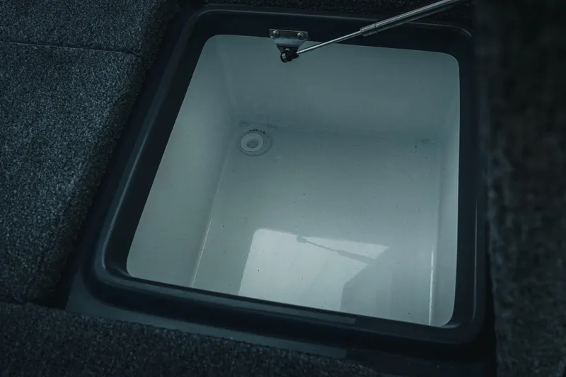 Slide: The Image of Open storage compartment in 2026 Phoenix 721 ZXL boat, featuring a clean interior. - 33