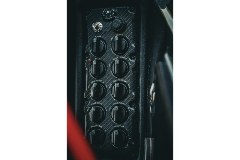 Slide: The Image of Control panel of 2026 Phoenix 721 ZXL boat with multiple switches and dials. - 39