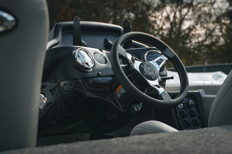 Slide: The Image of Steering wheel of 2026 Phoenix 721 ZXL boat, showcasing dashboard and controls. - 17