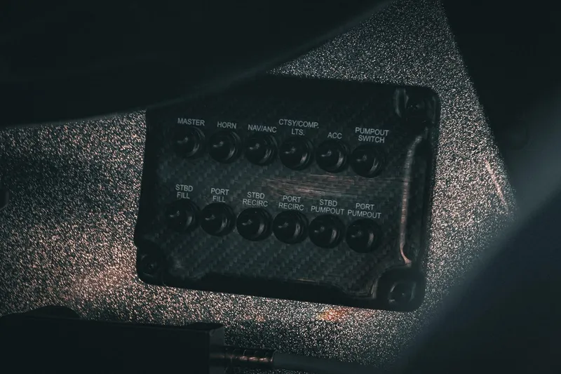 Slide: The Image of Control panel of a 2026 Phoenix 721 ZXL boat with various labeled switches. - 18