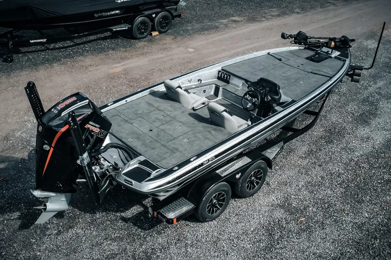 Slide: The Image of 2026 Phoenix 721 ZXL bass boat with dual axle trailer, featuring spacious deck and powerful engine. - 2