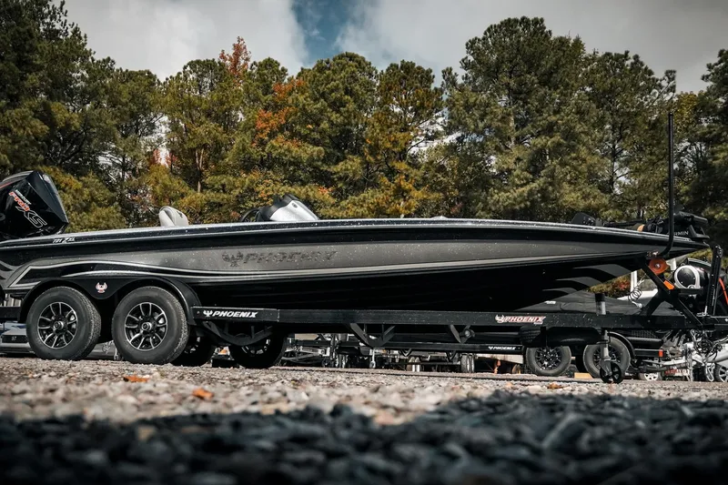 Slide: The Image of 2026 Phoenix 721 ZXL boat on trailer, surrounded by trees, showcasing sleek design. - 24