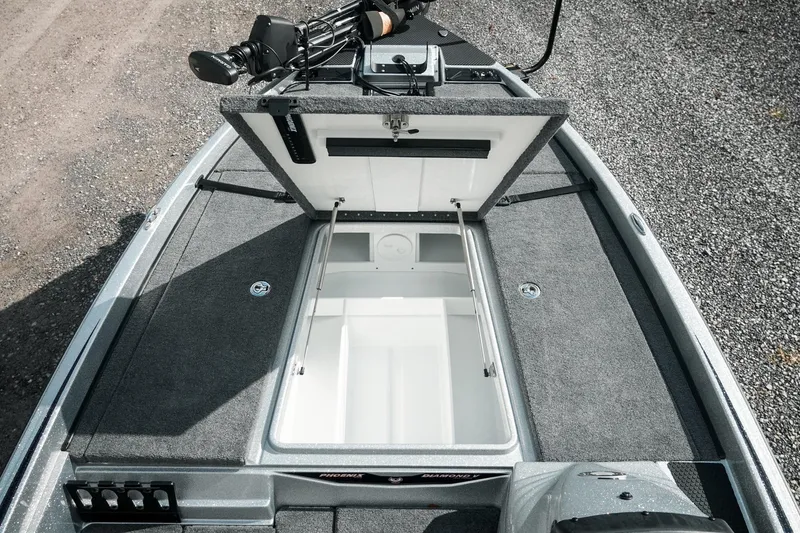 Slide: The Image of 2026 Phoenix 721 ZXL boat with open storage compartment, gray carpeted deck. - 28