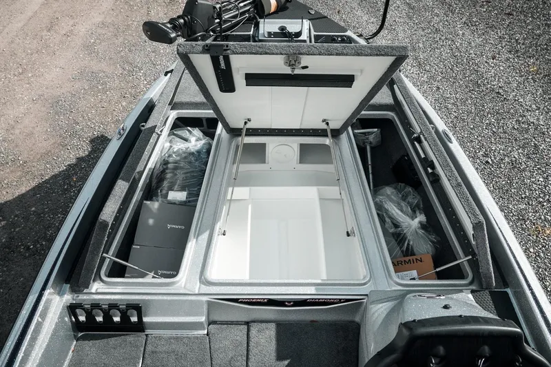Slide: The Image of Open storage compartments of 2026 Phoenix 721 ZXL boat, featuring Garmin equipment. - 29