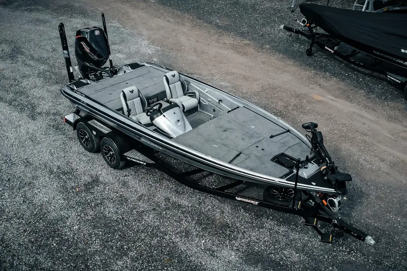 Slide: The Image of 2026 Phoenix 721 ZXL bass boat on trailer, parked on gravel surface. - 3