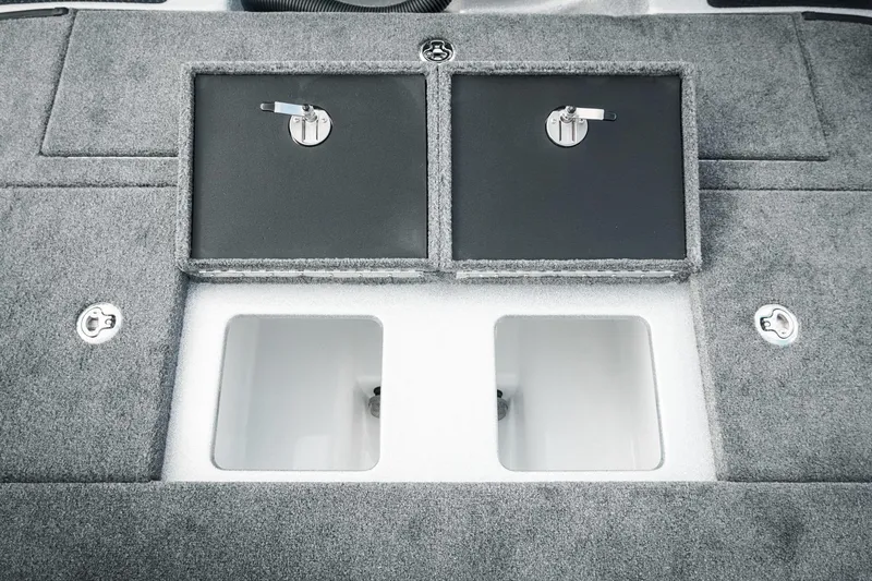 Slide: The Image of 2026 Phoenix 721 ZXL boat storage compartments with secure latches and carpeted finish. - 38