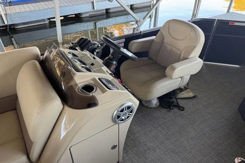 Slide: The Image of 2015 Crest 22 Crest I boat interior with beige captain's chair and control panel. - 10
