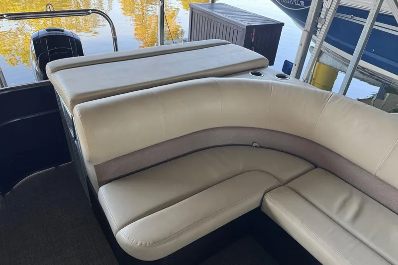 Slide: The Image of 2015 Crest 22 Crest I boat interior with beige seating and cup holders. - 11