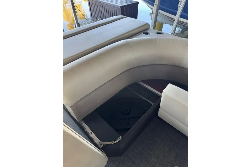 Slide: The Image of 2015 Crest 22 Crest I boat interior with cushioned seating and storage compartment. - 15