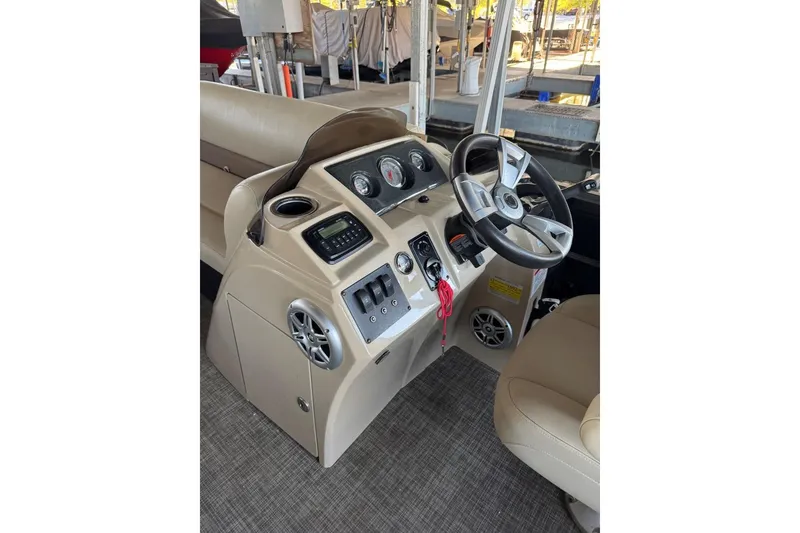 Slide: The Image of 2015 Crest 22 Crest I boat dashboard with steering wheel and controls. - 16