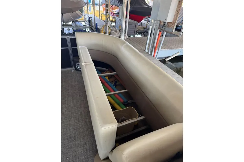 Slide: The Image of 2015 Crest 22 Crest I boat interior with beige seating and storage area. - 20