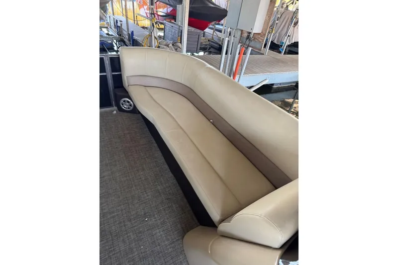 Slide: The Image of 2015 Crest 22 Crest I boat with beige seating and dock background. - 21