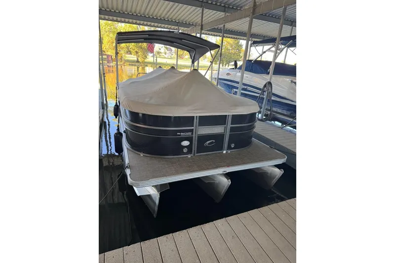 Slide: The Image of 2015 Crest 22 Crest I pontoon boat docked with cover in marina. - 28