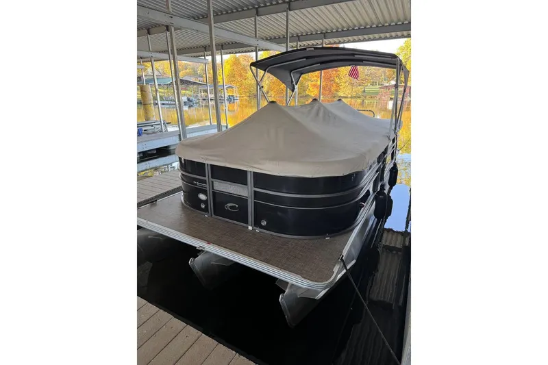 Slide: The Image of 2015 Crest 22 Crest I pontoon boat docked with cover under a canopy. - 29