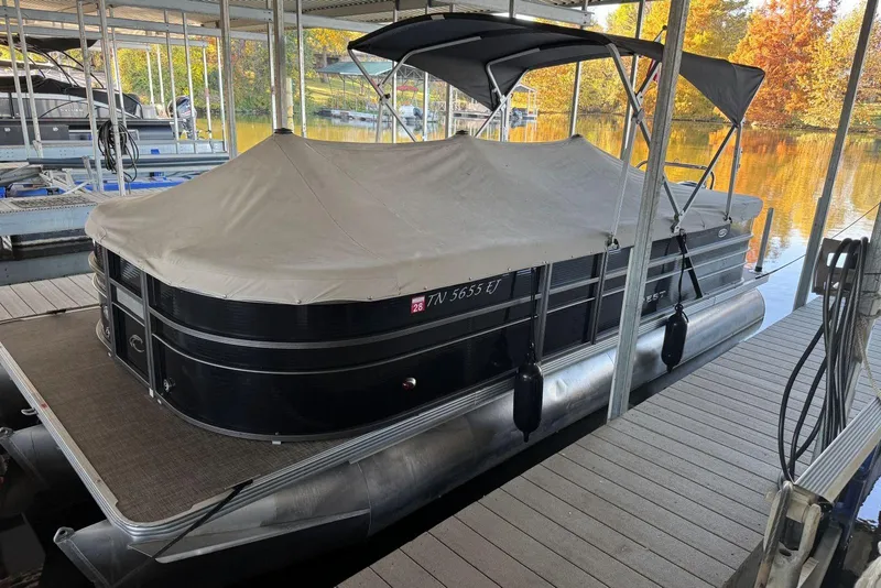 Slide: The Image of 2015 Crest 22 Crest I pontoon boat docked with cover, surrounded by autumn foliage. - 30