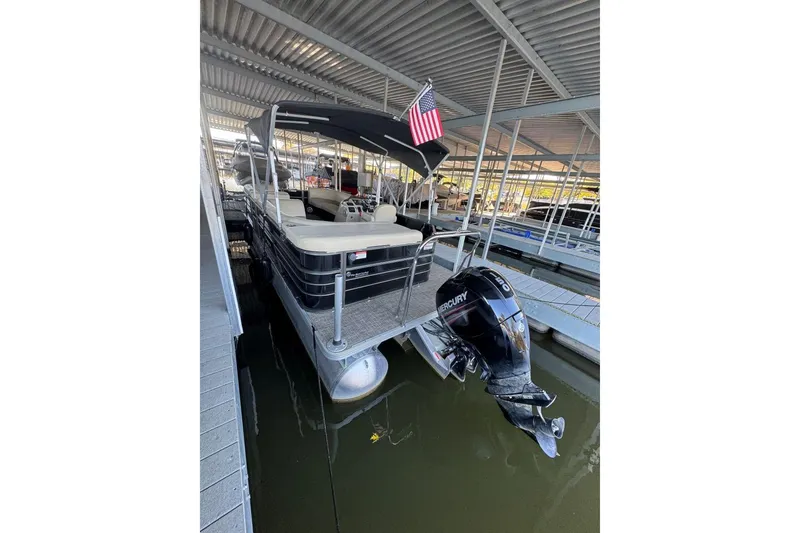 Slide: The Image of 2015 Crest 22 Crest I pontoon boat docked with Mercury outboard motor. - 4