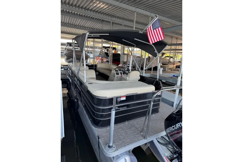 Slide: The Image of 2015 Crest 22 Crest I pontoon boat with canopy and American flag in marina. - 5