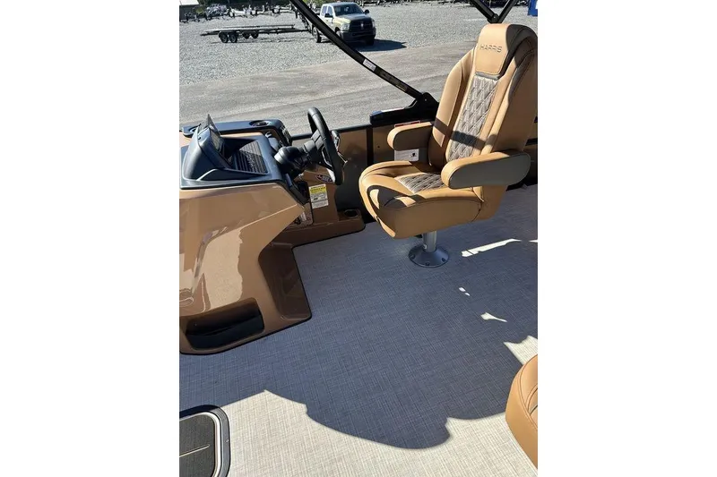 Slide: The Image of Luxurious interior of 2026 Harris Cruiser 250 LUX boat with tan captain's chair. - 10