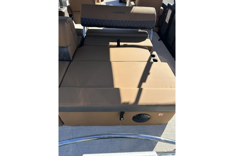 Slide: The Image of 2026 Harris Cruiser 250 LUX boat interior with tan seating and cup holders. - 11