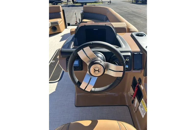 Slide: The Image of 2026 Harris Cruiser 250 LUX boat dashboard with steering wheel and control panel. - 4