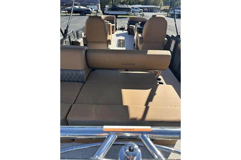 Slide: The Image of 2026 Harris Cruiser 250 LUX pontoon boat with luxurious tan seating and spacious interior. - 8