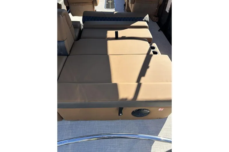 Slide: The Image of 2026 Harris Cruiser 250 LUX boat interior with tan seating and cup holders. - 9