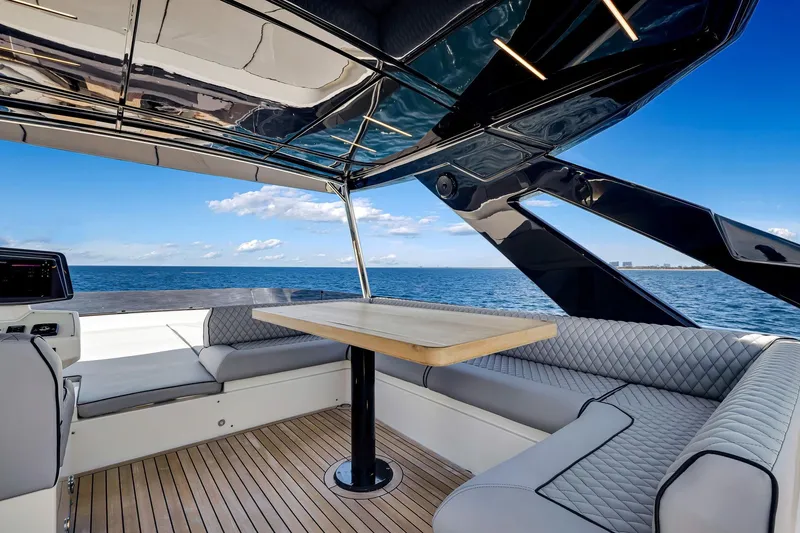 Slide: The Image of Luxurious 2022 Ferretti Yachts 670 interior with ocean view, featuring elegant seating and table. - 18