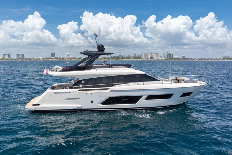 The Image of 2022 Ferretti Yachts 670 cruising on open water under a clear blue sky. - 0