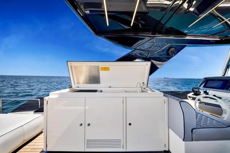 Slide: The Image of Luxurious 2022 Ferretti Yachts 670 with sleek outdoor kitchen and ocean view. - 21