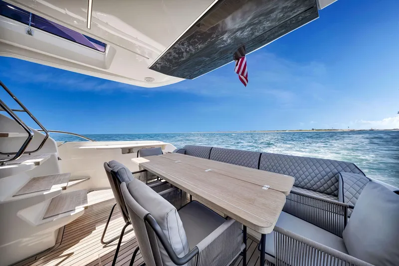 Slide: The Image of Luxurious 2022 Ferretti Yachts 670 deck with elegant seating and ocean view. - 25