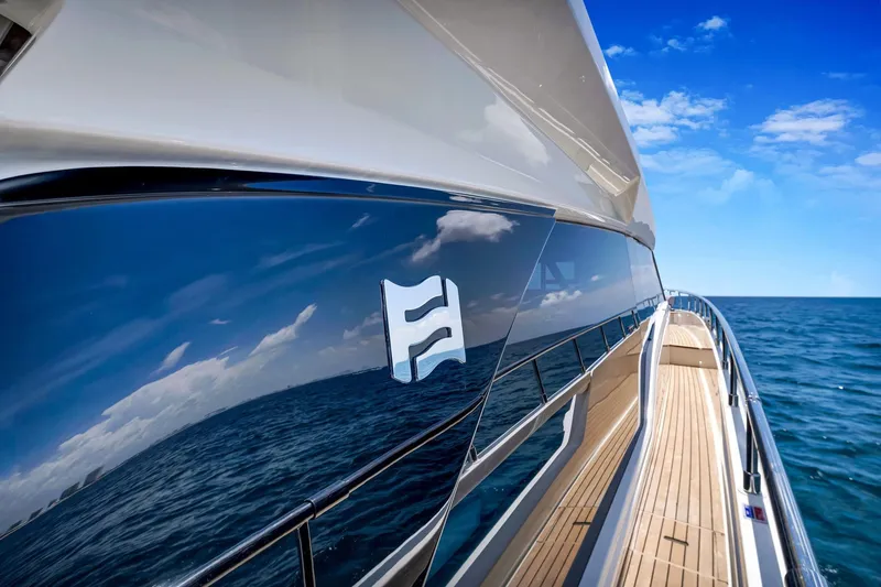 Slide: The Image of 2022 Ferretti Yachts 670 reflecting ocean and sky, sleek design, luxury yacht exterior. - 6