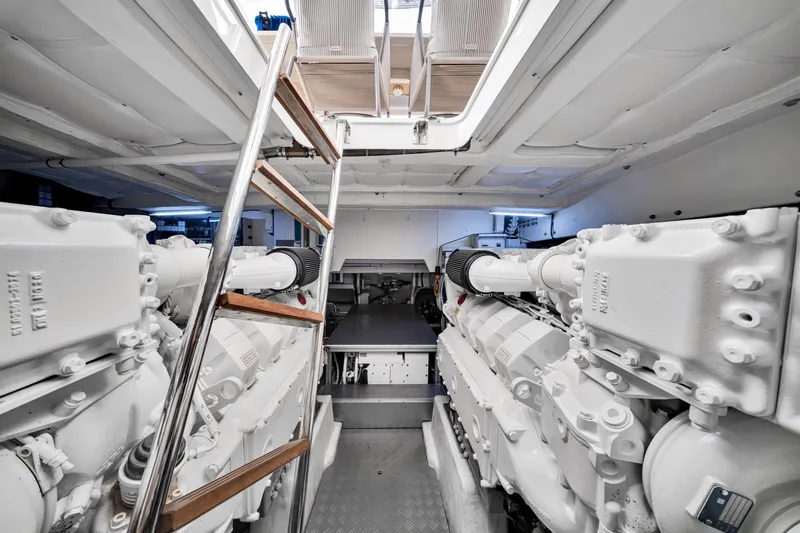 Slide: The Image of Engine room of 2022 Ferretti Yachts 670, featuring dual engines and ladder access. - 60