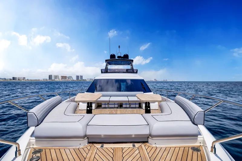 Slide: The Image of Luxurious 2022 Ferretti Yachts 670 on open sea with city skyline. - 7
