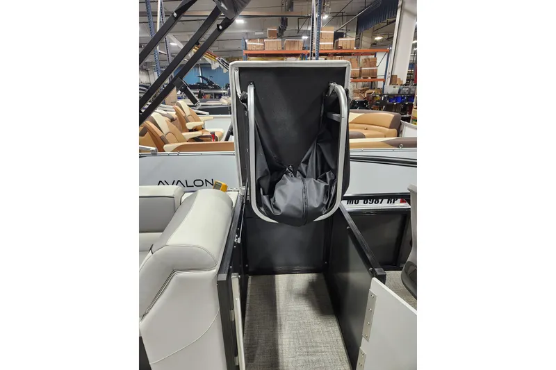 Slide: The Image of 2026 Avalon Venture 85 Center Console Fish boat interior with storage compartment open. - 10